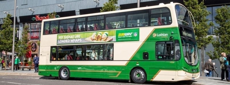 Lothian Country bus parked alongside bus stops at The Centre in Livingston.