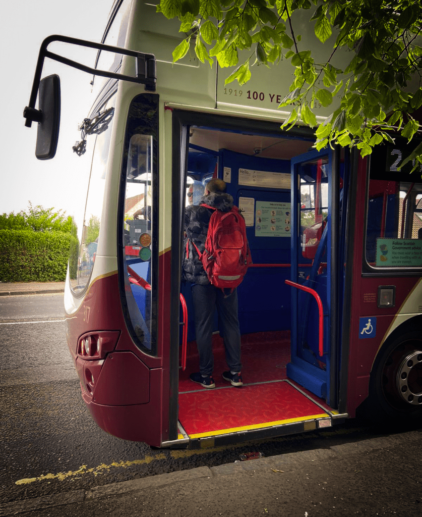 Image of a man boarding a Lothian bus