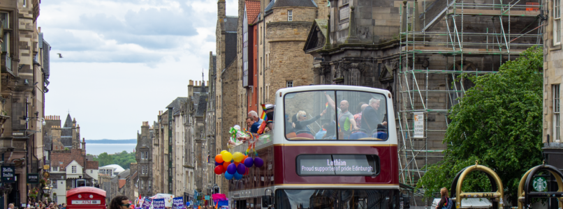 Lothian open-top bus leads the Pride Edinburgh parade up the Royal Mile.