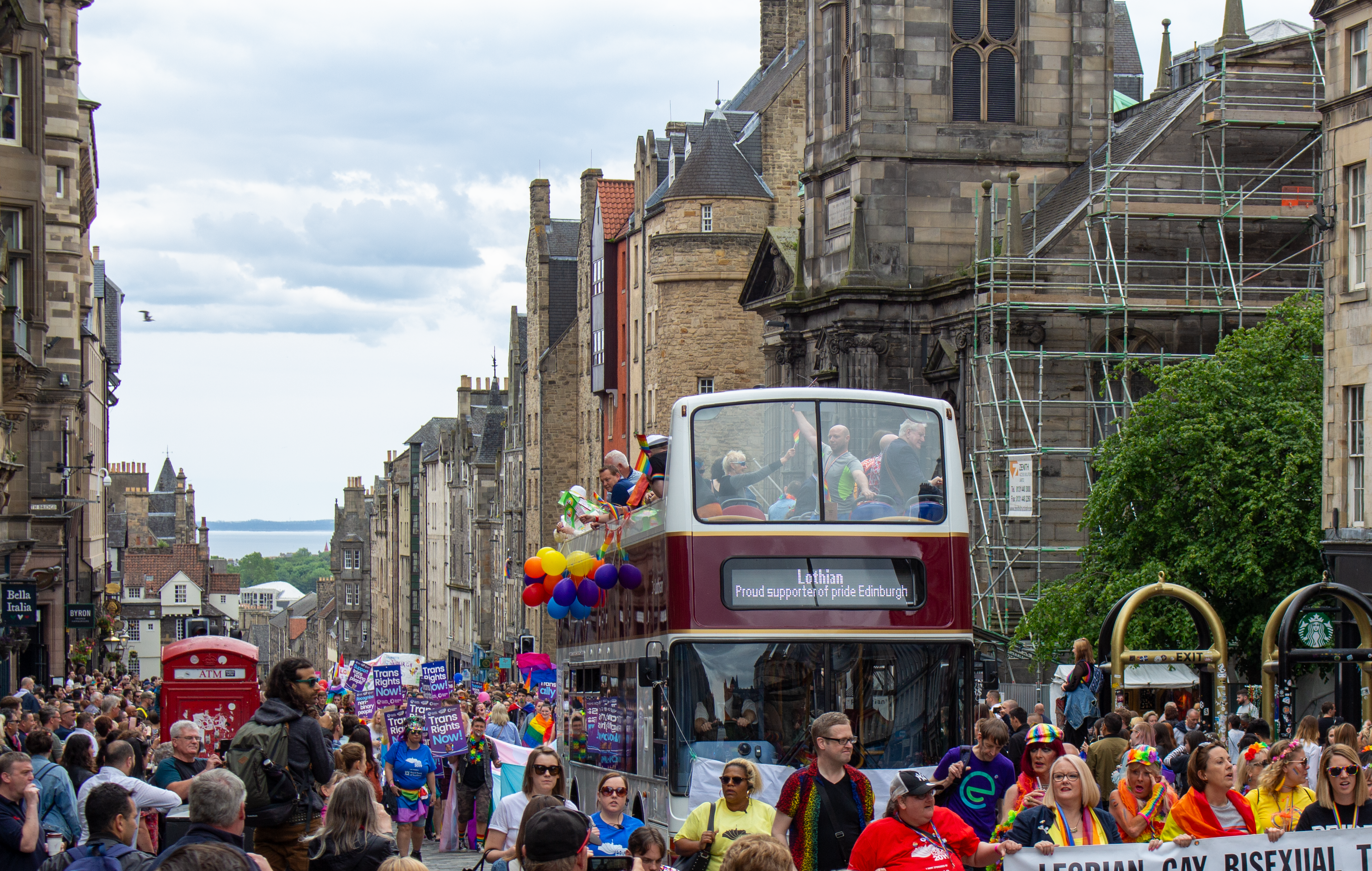 Lothian open-top bus leads the Pride Edinburgh parade up the Royal Mile.