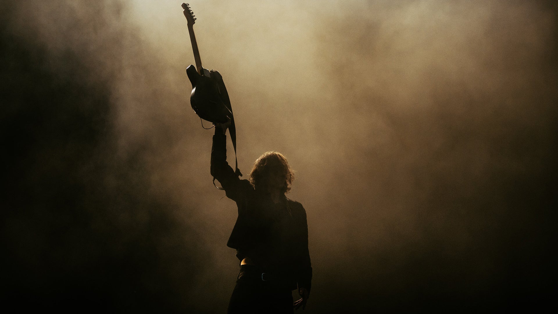 A silhouette of the lead guitarist of Catfish and the Bottlemen.