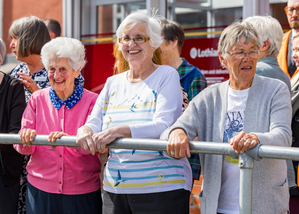 Service users from North Edinburgh Dementia Care standing smiling at the launch event.